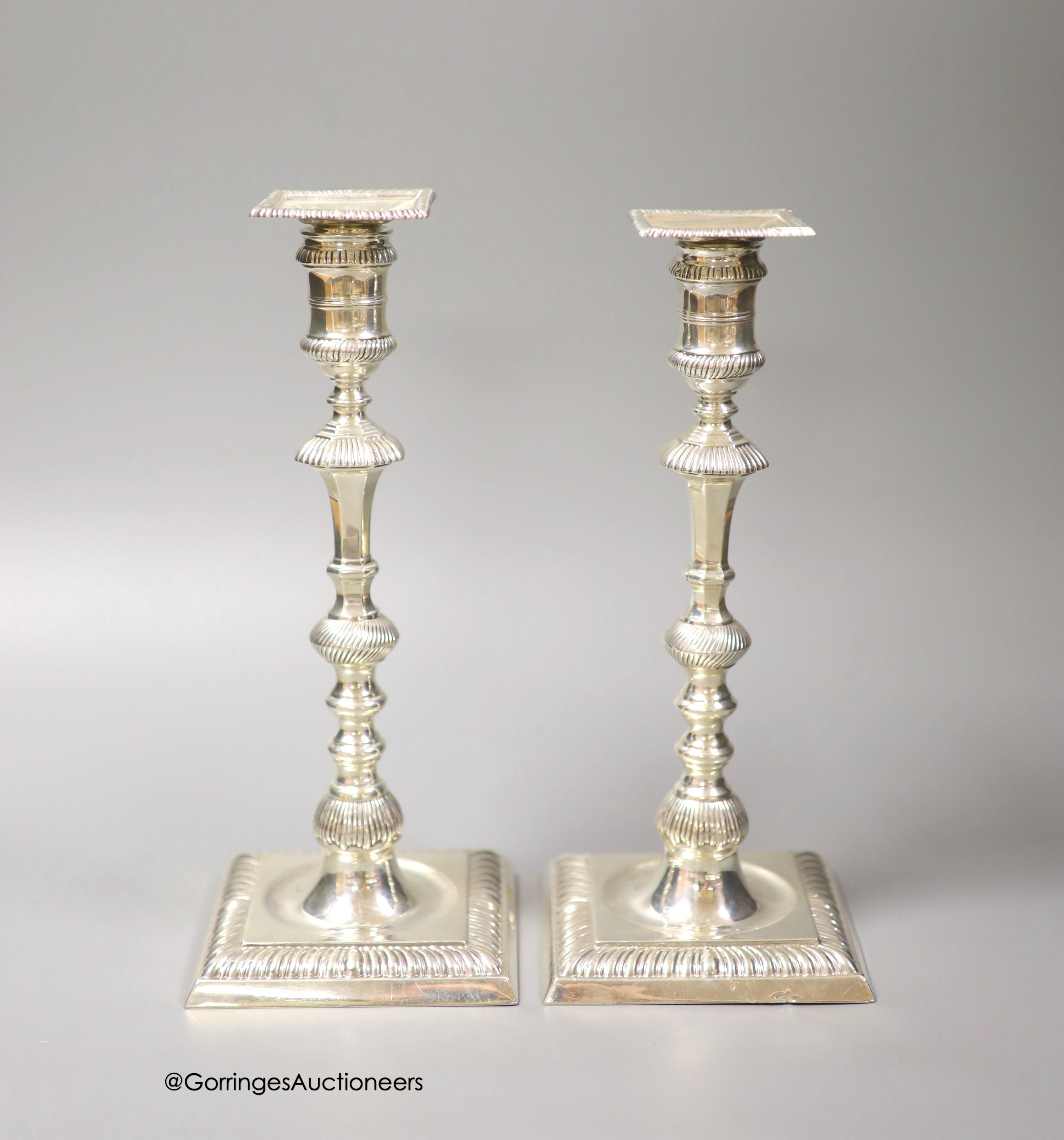 A matched pair of late Victorian/Edwardian silver candlesticks, Thomas Bradbury & Sons, London, 1893/4 & London, 1905, 26.2cm, weighted